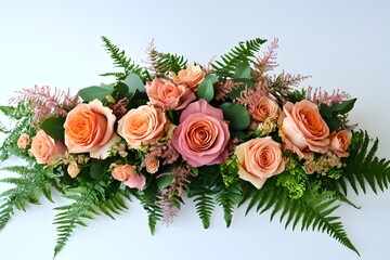 Elegant floral arrangement with pink and peach roses on greenery