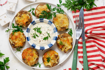 Baked mushrooms stuffed with cheese with sauce.selective focus