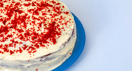 Traditional and delicious red velvet cake isolated on blue plate