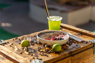 a bowl with drink and fruit 