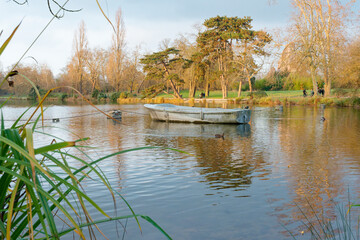 Bois de Vincennes displays tranquil waters and lush greenery as visitors enjoy a peaceful day in...
