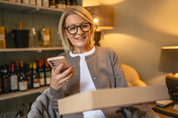 woman entrepreneur scan package with cellphone in the antique shop