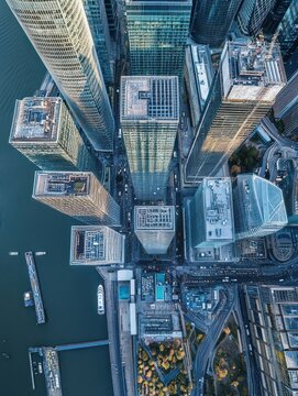 Aerial bird's eye view photo taken by drone of famous Canary Wharf skyscraper complex, Isle of Dogs, London, United Kingdom