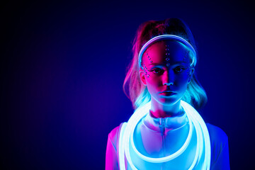 Gorgeous lady having glowing led light cable wearing cosmic princess costume look on ultraviolet color background