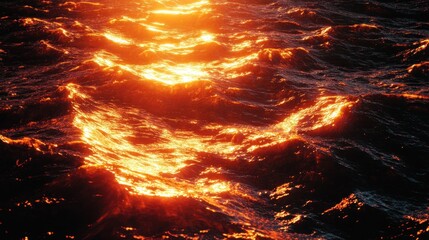 Fiery sunset reflecting on ocean waves.