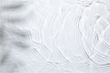 Rippled surface of clear water on white background, top view