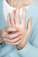 Close-up of a mature woman's hands suffering rheumatoid arthritis pain.