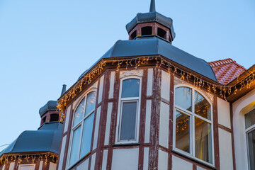 Decorative Lights Illuminate a Charming Historic Building in the Evening Sky