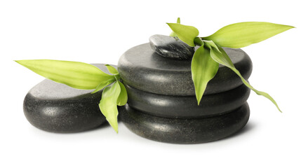 Spa stones and green leaves isolated on white
