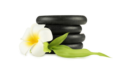 Spa stones, plumeria flower and green leaves isolated on white