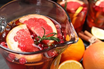 Delicious punch with rosemary in jug, closeup