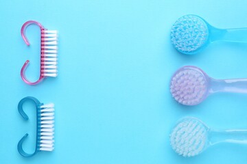 Pedicure procedure. Different brushes on light blue background, flat lay. Space for text