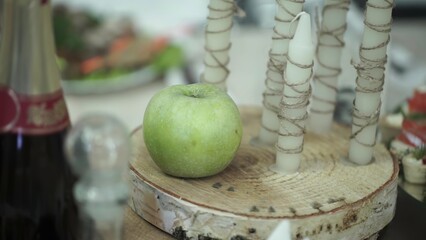 A vibrant green apple on rustic wooden surfaces creates a cozy vibe