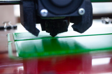 The process of printing on 3D printer. 3D printer creating model from molten plastic close-up. Molten plastic flowing of extruder and forming three-dimensional volumetric object. Additive technologies