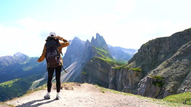 Tourist enjoying the odle and seceda mountains in the dolomites in summer