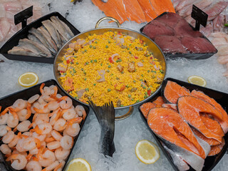 Delicious Seafood Paella Surrounded by Fresh Fish