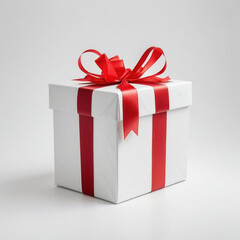 Fototapeta premium A wrapped gift box with a red ribbon bow on a white background