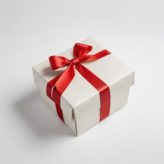 A wrapped gift box with a red ribbon bow on a white background