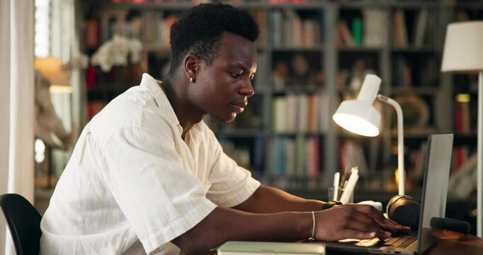 Education, university student and typing on laptop in home for research proposal, masters thesis or project deadline. Scholarship, black man and writing online report for college assignment at night