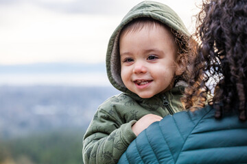 Smiling Child In Green Jacket With Scenic Background On Vancouver Island