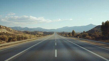 Naklejka premium Scenic Rural Highway Stretching into Distant Mountains under Blue Sky : Generative AI