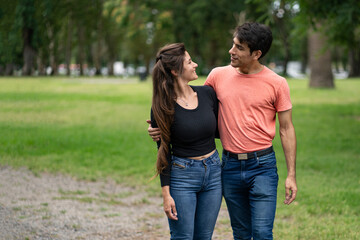 Young couple in love walking arm in arm in the park