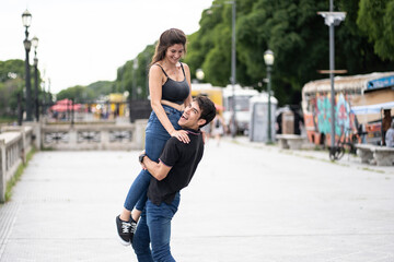 Young boy lifting his happy girlfriend
