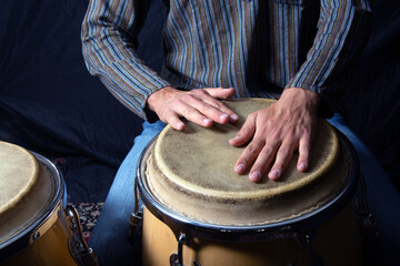 Close-Up of Hands Playing Conga Drums