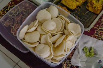 A close-up of delicious homemade shrimp crackers in a plastic box.