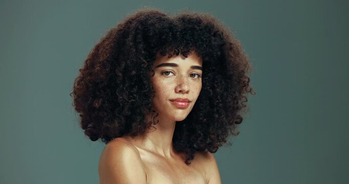 Hair, confident and face of woman in studio with natural texture, curly hairstyle and wellness. Salon, haircare and portrait of person for cosmetics, products and shampoo treatment on background