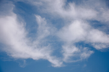 various shapes of clouds on different levels of blue background