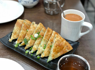 Chinese Scallion Pancakes with a cup of hot Hong Kong milk tea