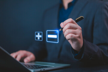 Plus and minus concept, A businessman use plus minus icons displayed opposites concept, He point to...