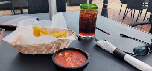 Outdoor Dining with Chips, Salsa, and Refreshing Cold Beverage on a Summer Day