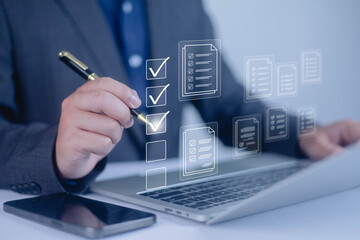 Business performance checklist concept, Take an assessment business man, Businessman using laptop...