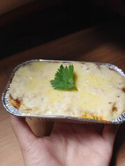 Creamy lasagna in aluminum foil cup