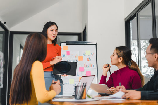 woman presenting ideas to team in modern office