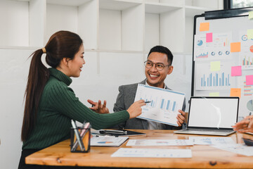 Business team discussing charts in meeting room