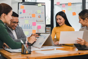Team collaborating on business strategy with charts and graphs
