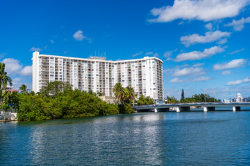 Obraz premium Luxury waterfront house. Hotel building architecture at bridge. Residential architecture building. Residential apartment in waterfront city. City waterfront with house. Vacation building in summer