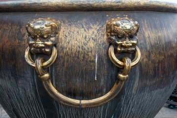 Ancient bronze lions as a handle of vat in Forbidden City,