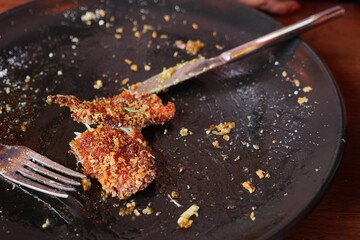 An empty dirty plate with a fork.