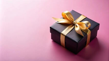 Fototapeta premium Black gift box on a pink background with gold ribbons, ideal for product promotions or special events, gift box