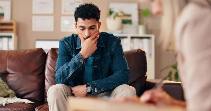 Therapist, sad man and patient with office discussion, advice and mental health check at consultation. Psychologist, counseling and sofa with conversation, meeting and professional care with notes