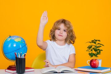 School child raising hands, willing to answer question. Nerd school kid isolated on studio...