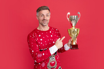 amazed xmas guy celebrating success on red background. happy new year.