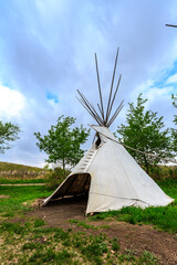 A teepee is standing in a grassy field © Scott Prokop