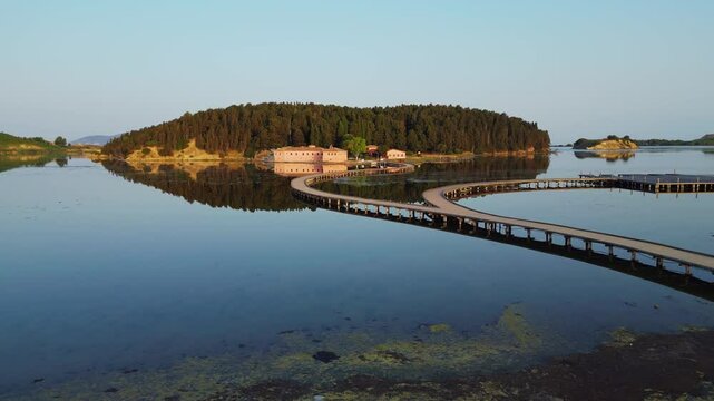 Flying a drone at low altitude over Narta Lagoon, capturing unique perspectives while gradually approaching the remarkable Zvernec Monastery