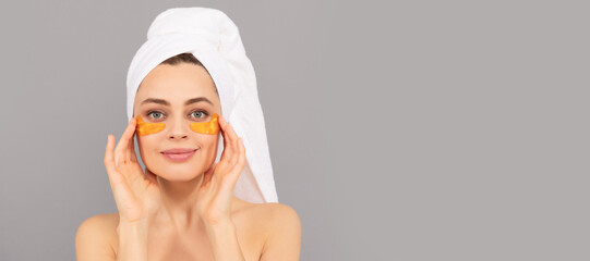 Woman with beauty face, facial skin portrait. young woman with terry towel use facial golden eye patch for skin, skin. Beautiful woman isolated face portrait, banner with mock up copy space.