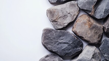 Natural large stone cobblestones ideal for baths and saunas arranged on a clean white background showcasing their texture and color.